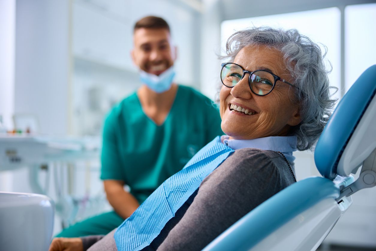 Older adult smiling during a dental visit